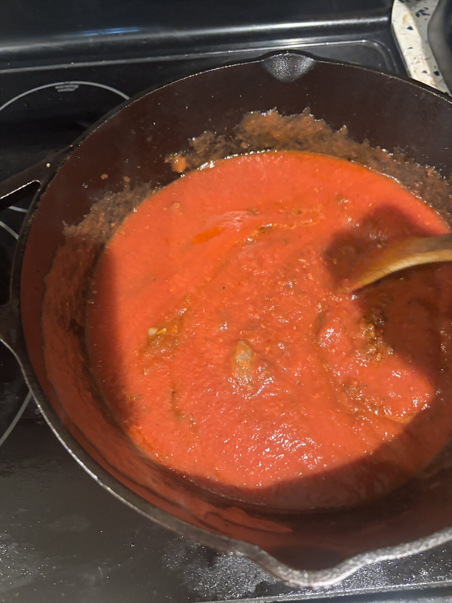 Bright red tomato sauce just added to the pan