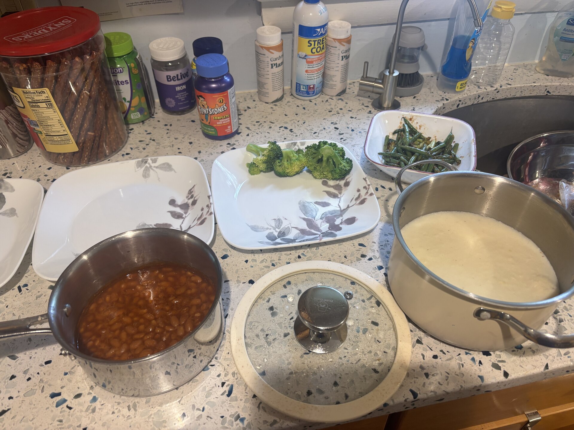 sides spread on counter — mashed potatoes, baked beans, broccoli, green beans